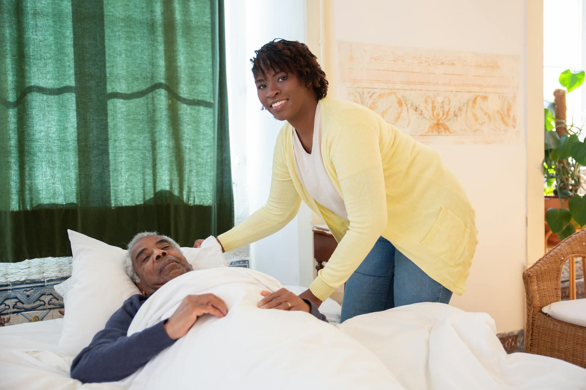 A caregiver tending to a member at the bedside